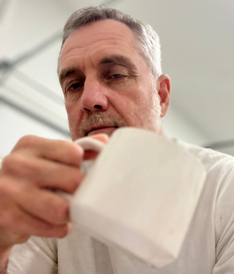 Artist Robert Joyner with coffee cup at 4:30am - the face behind the garage studio art tutorials.
