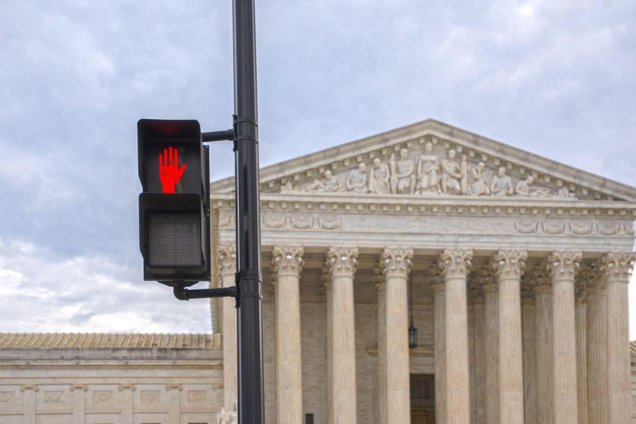 Stop sign outside Supreme Court building. Supreme Court strikes down coordinated spending caps on parties.
