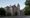 A three-storey nineteenth-century stone building photographed from across a culdesac.