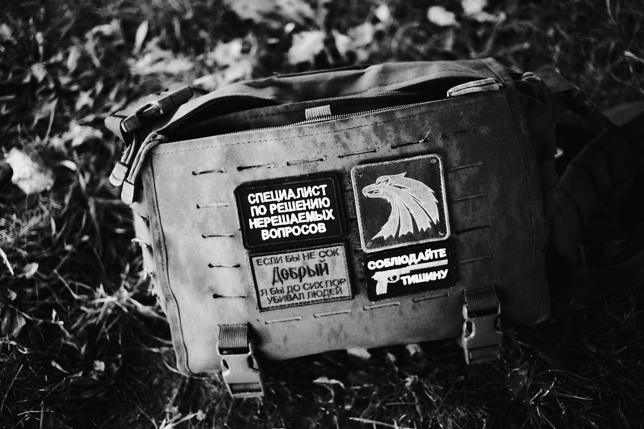 В мирной жизни Максин сопровождают символы, связанные с войной и армейской службой. В их числе — нашивки на сумке.