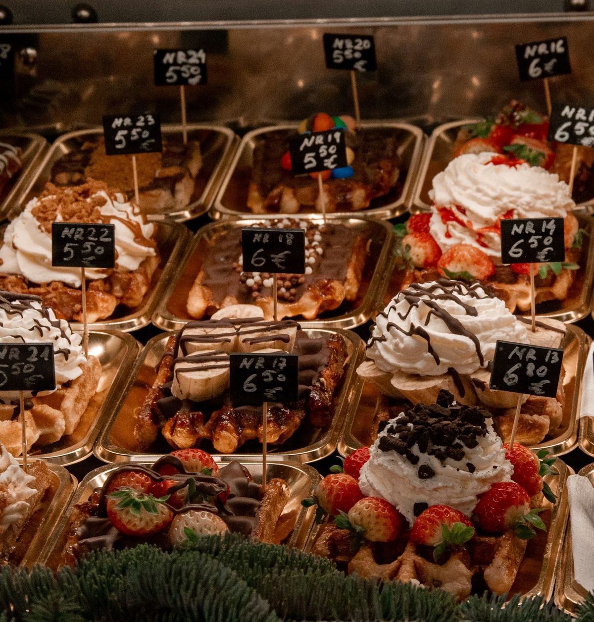A glass display case filled with different waffles of deluxe flavours