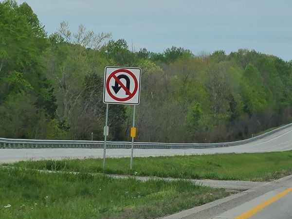 No U-turn sign in the median of a divided highway