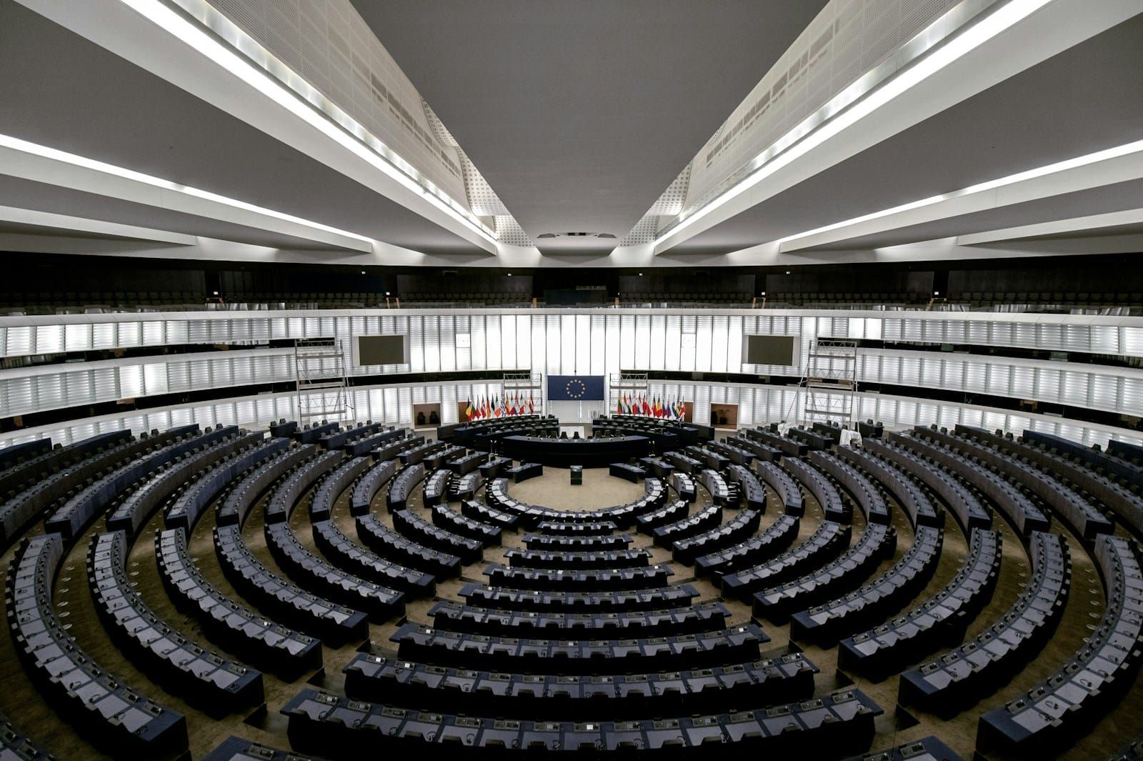 Overhead view of a circular plenary assembly chamber with concentric rows of delegate seats.
