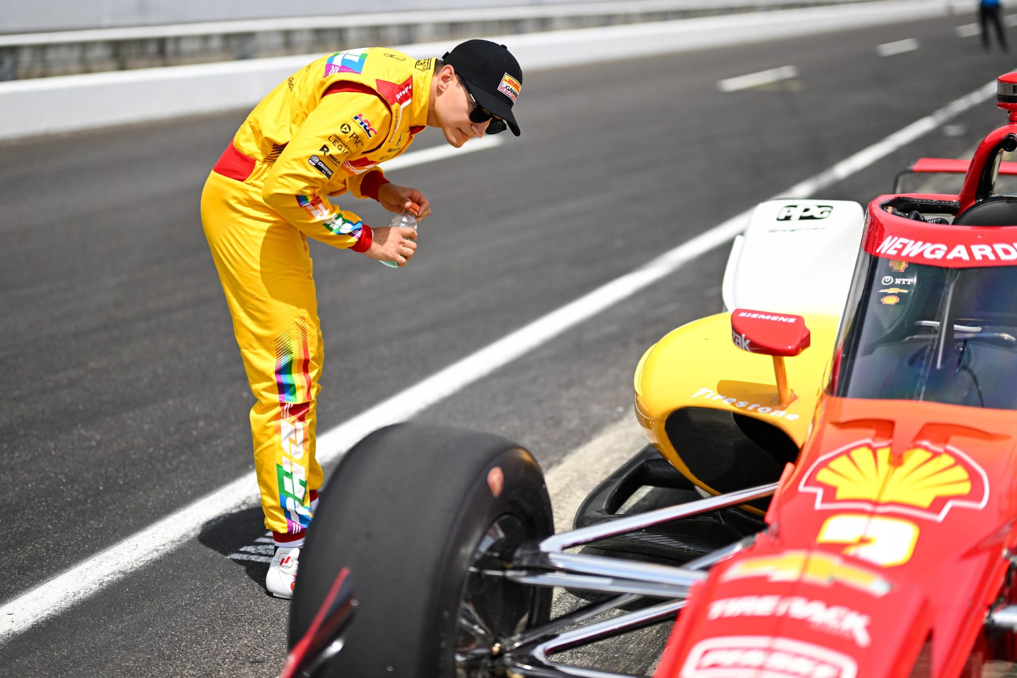 Alex Palou looking at Josef Newgarden's IndyCar