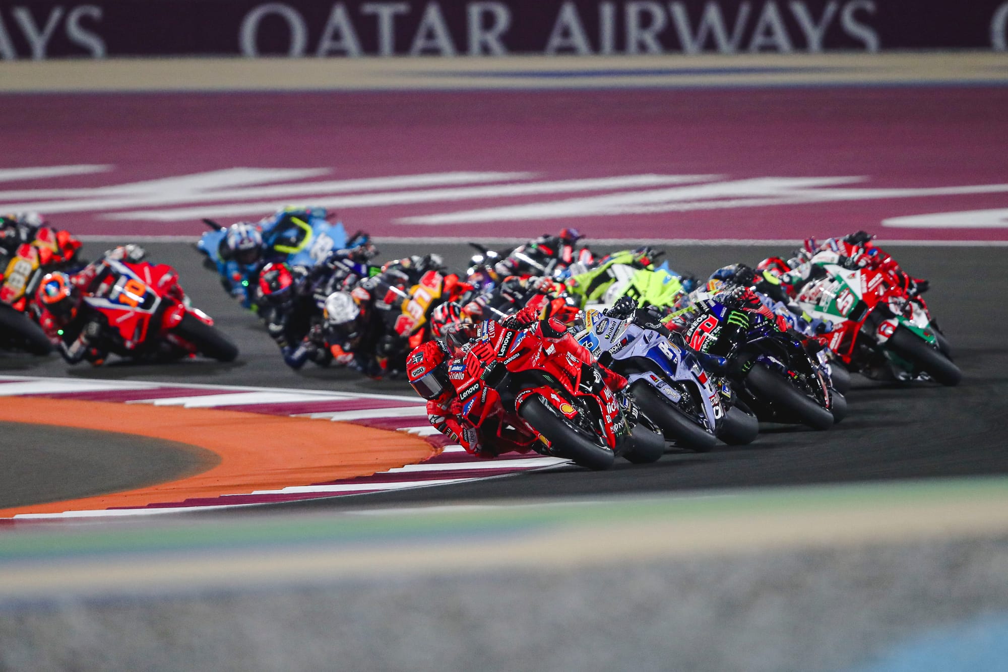 The field races through Turn 1 at MotoGP's Qatar Grand Prix