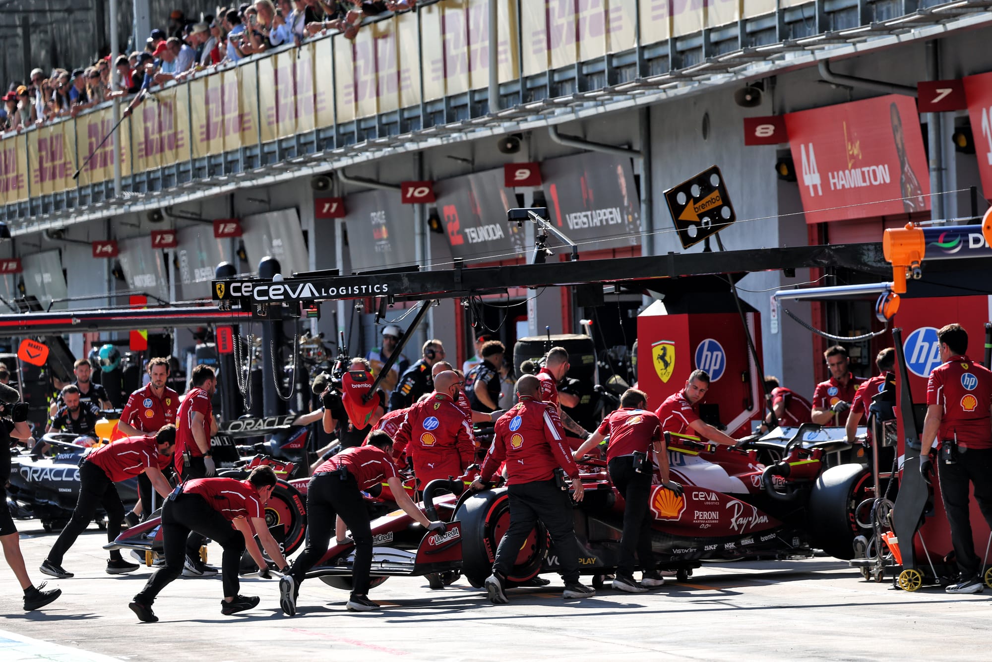 Leclerc's Ferrari is wheeled into the pits during 2025 Imola qualifying