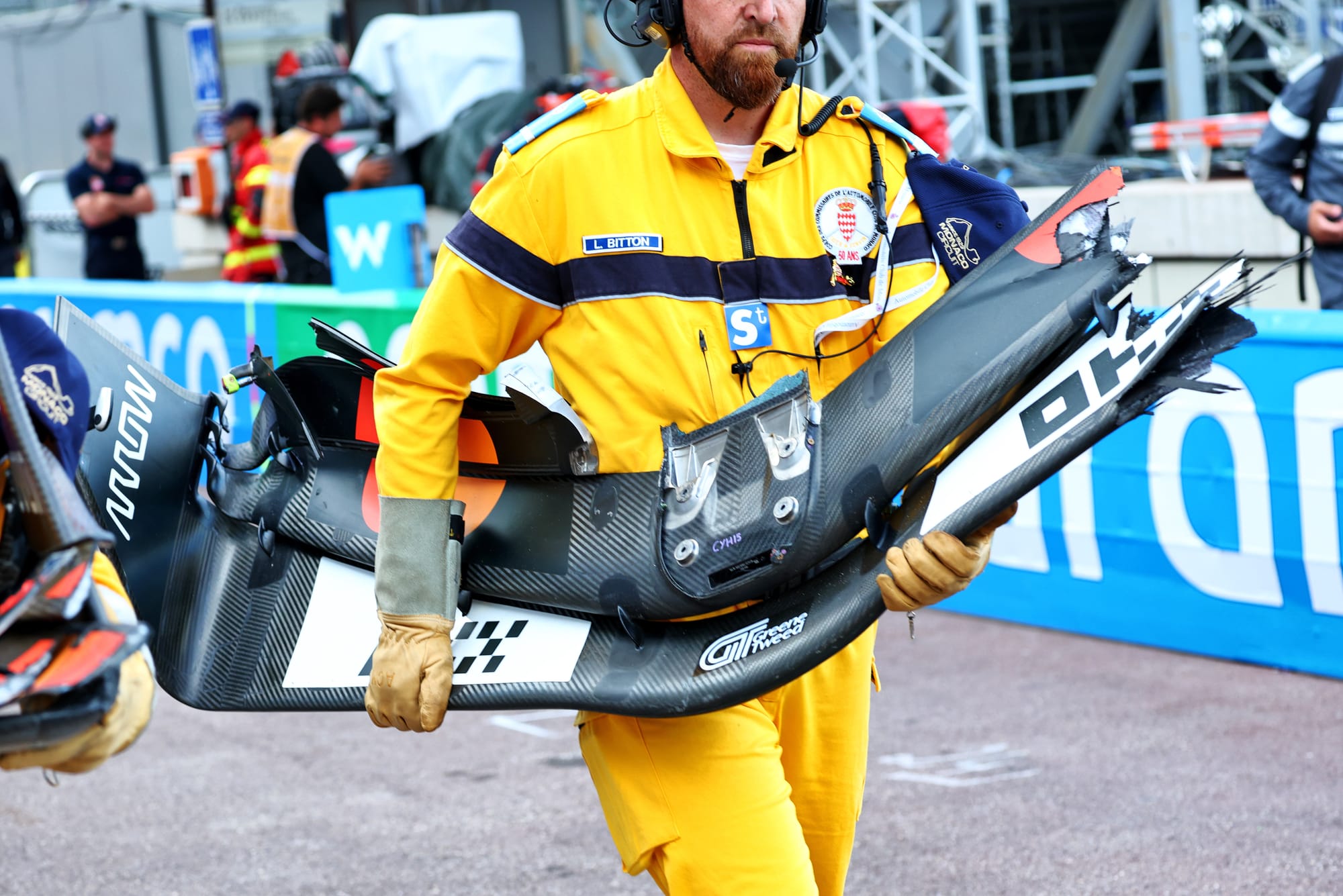 Marshal with Oscar Piastri's front wing in Monaco Grand Prix practice 2025