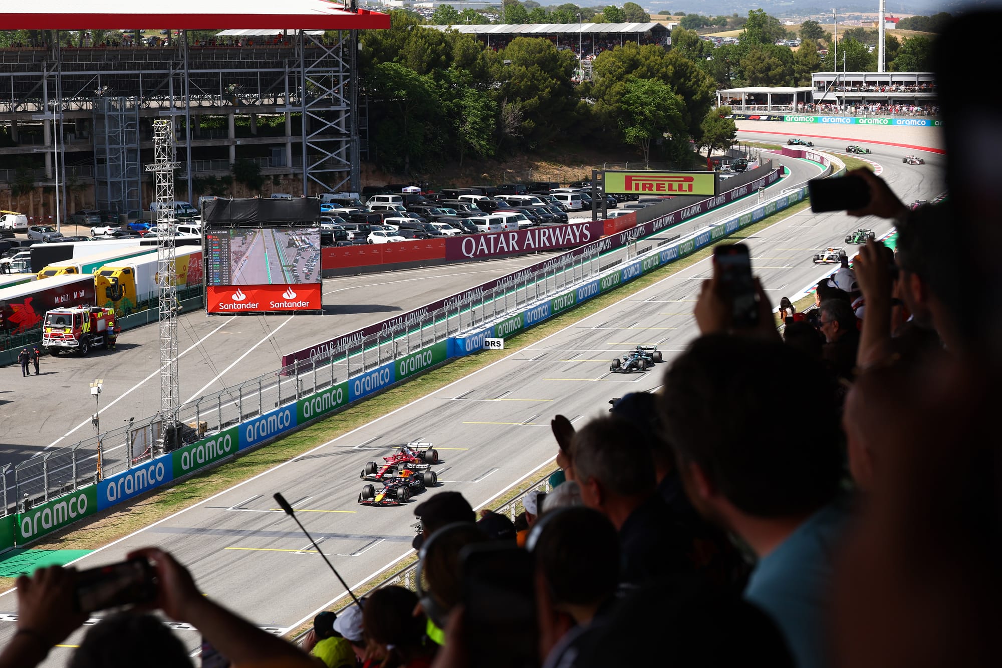 Verstappen battles Leclerc and Russell, Spain 2025 F1, with crowd watching on