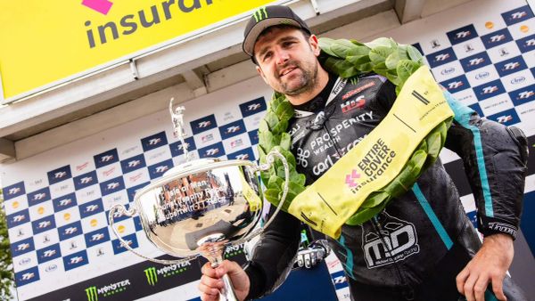 Michael Dunlop holds his trophy after winning a Supertwin TT in 2025