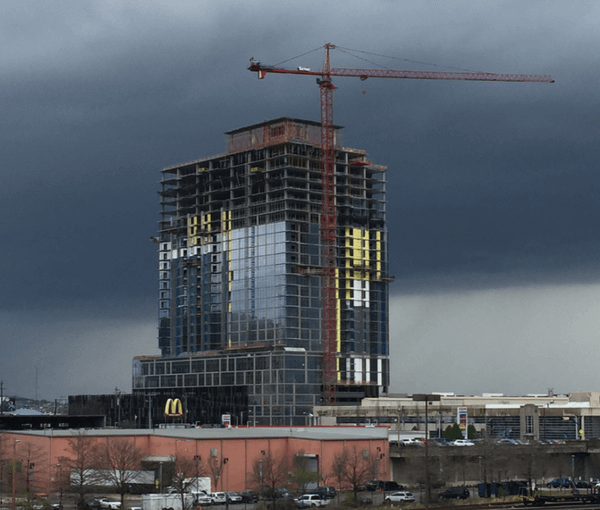 Half-built skyscraper before a dark gray sky - Moral Letters to Lucilius