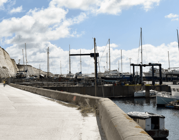 Bike path along a waterway with boats in the harbor - Moral Letters to Lucilius