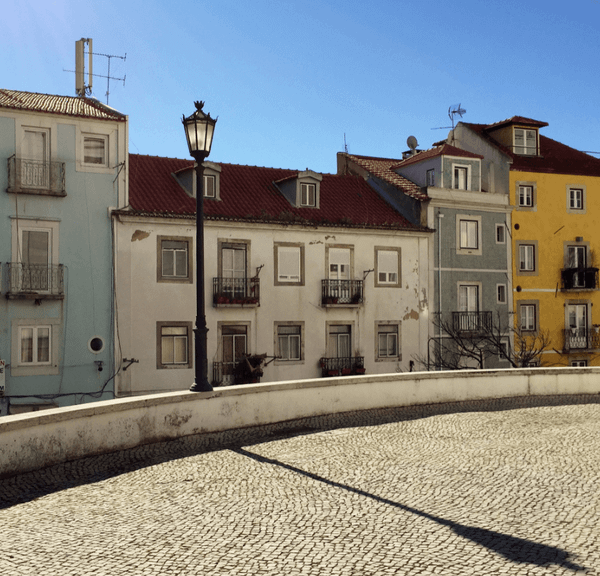 Cobblestone street fronting a row of Mediterranean-style stone houses
