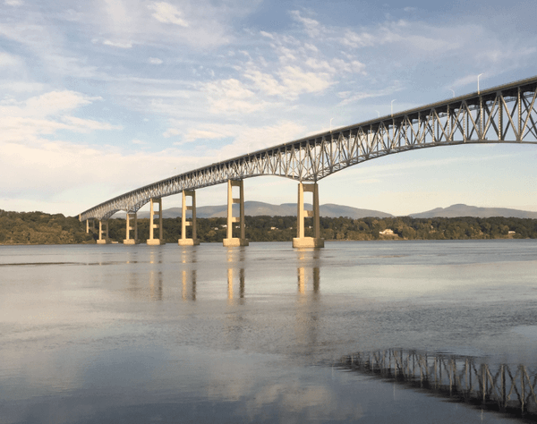 A long trestle bridge crossing a wide river