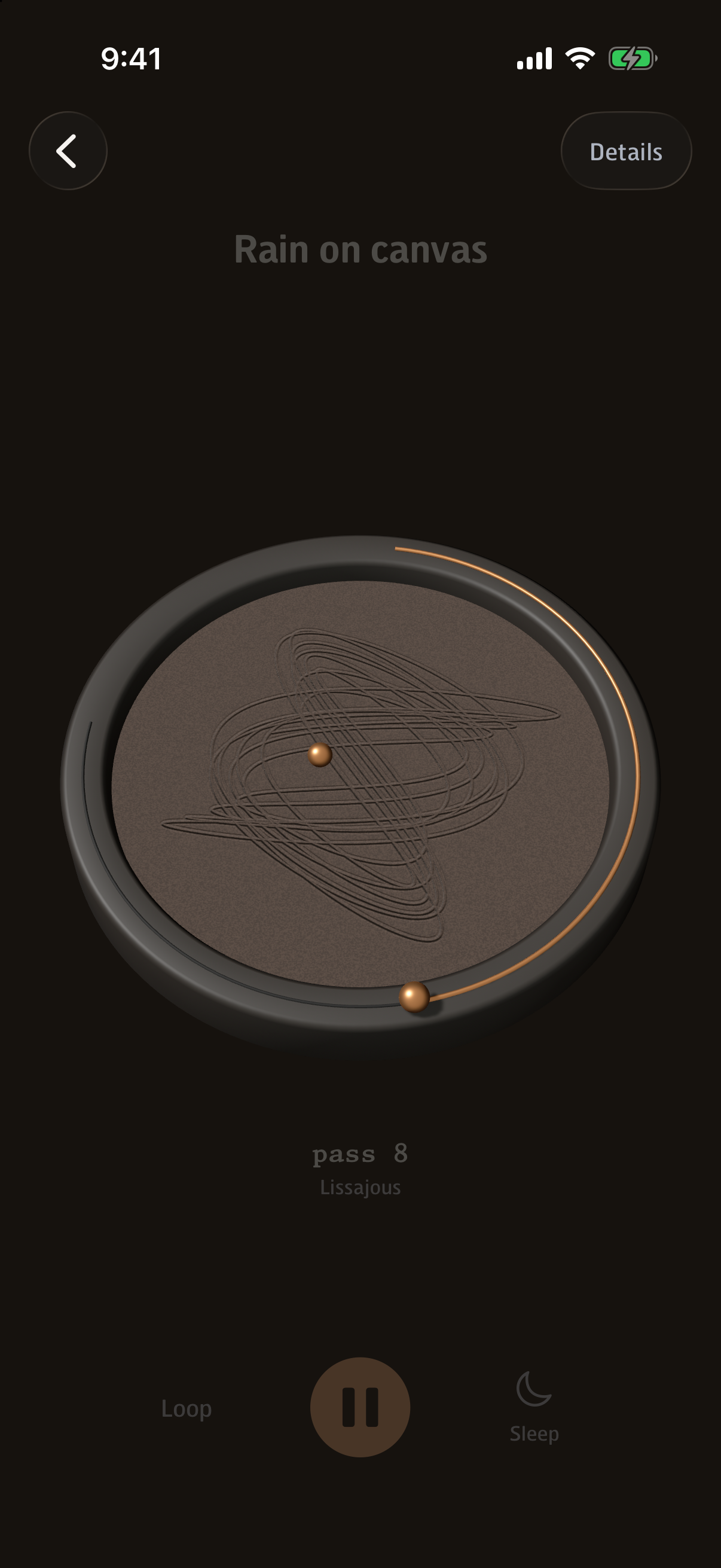 The sand table tilted and turning on its own, the drawing's grooves catching the light.