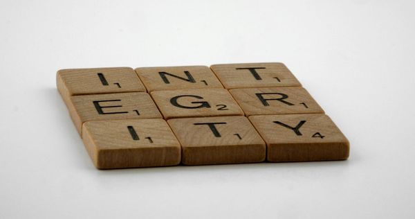 Wooden blocks with letters spelling out "integrity".