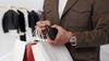 Man holding wallet and shopping bags