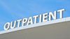 "Outpatient" sign atop the roof of a healthcare facility