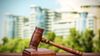 Buildings in the background and a gavel in the foreground