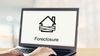 "Foreclosure" page shown on a laptop screen