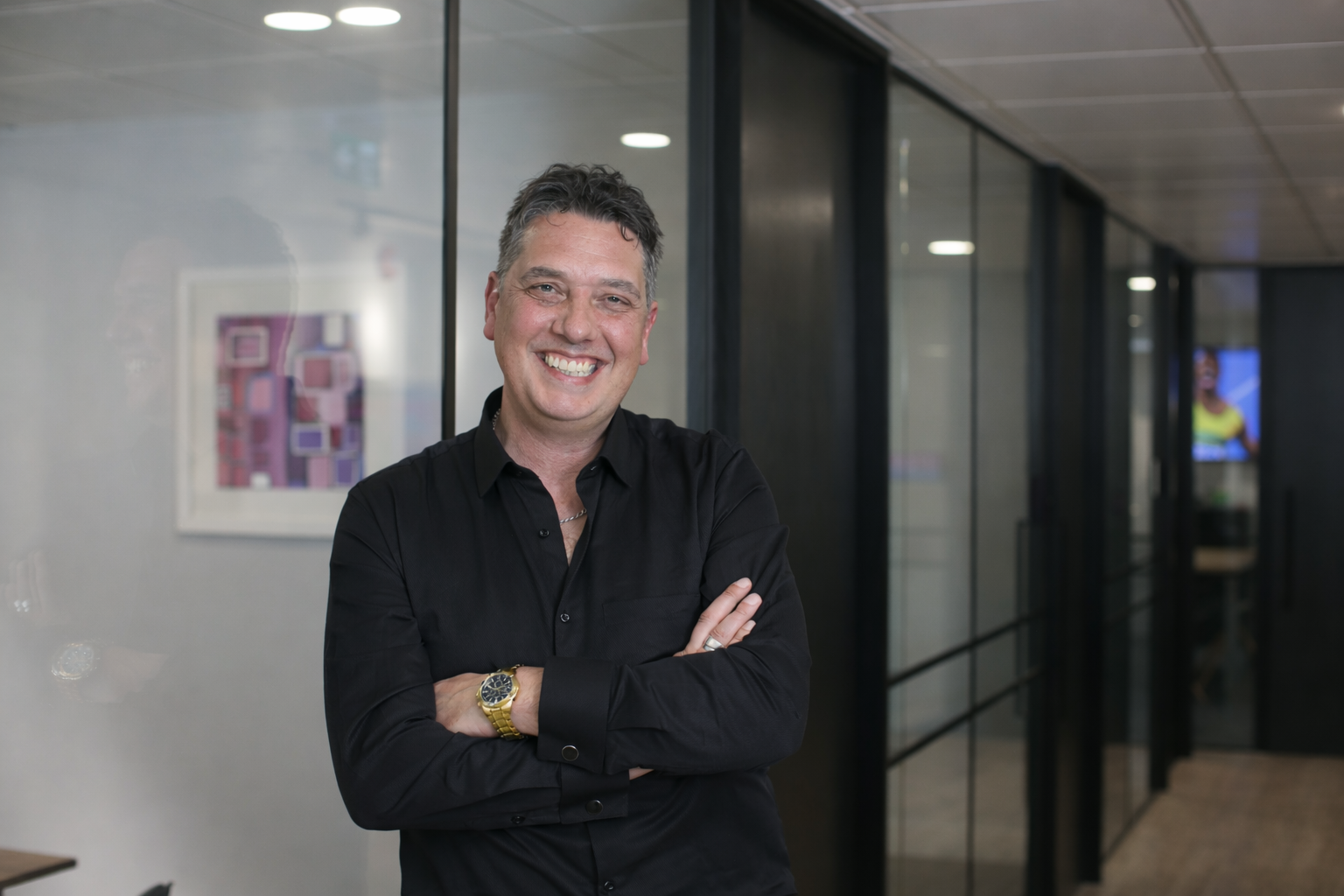 Digital Expert Elliott King smiling in a casual business setting.