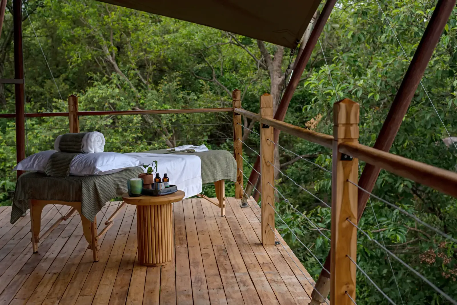 A spa massage table on a forest-view deck at Pabidi Lodge