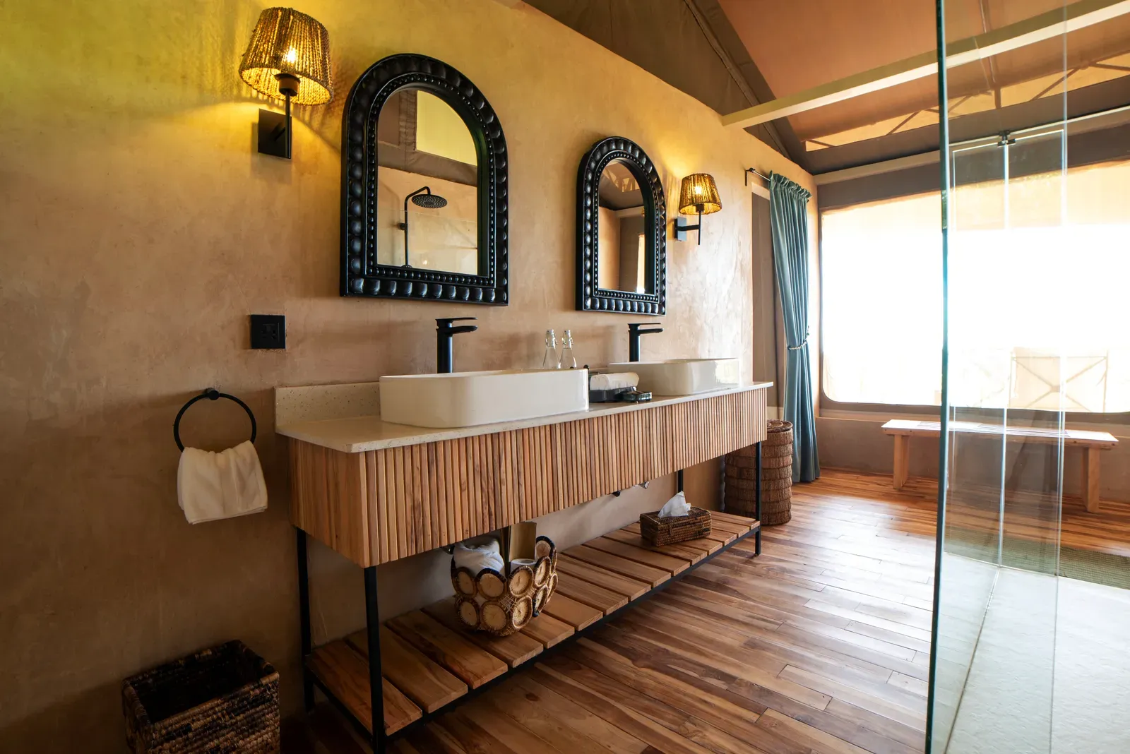 An en-suite bathroom with double vanity in a tented suite at Pabidi Lodge