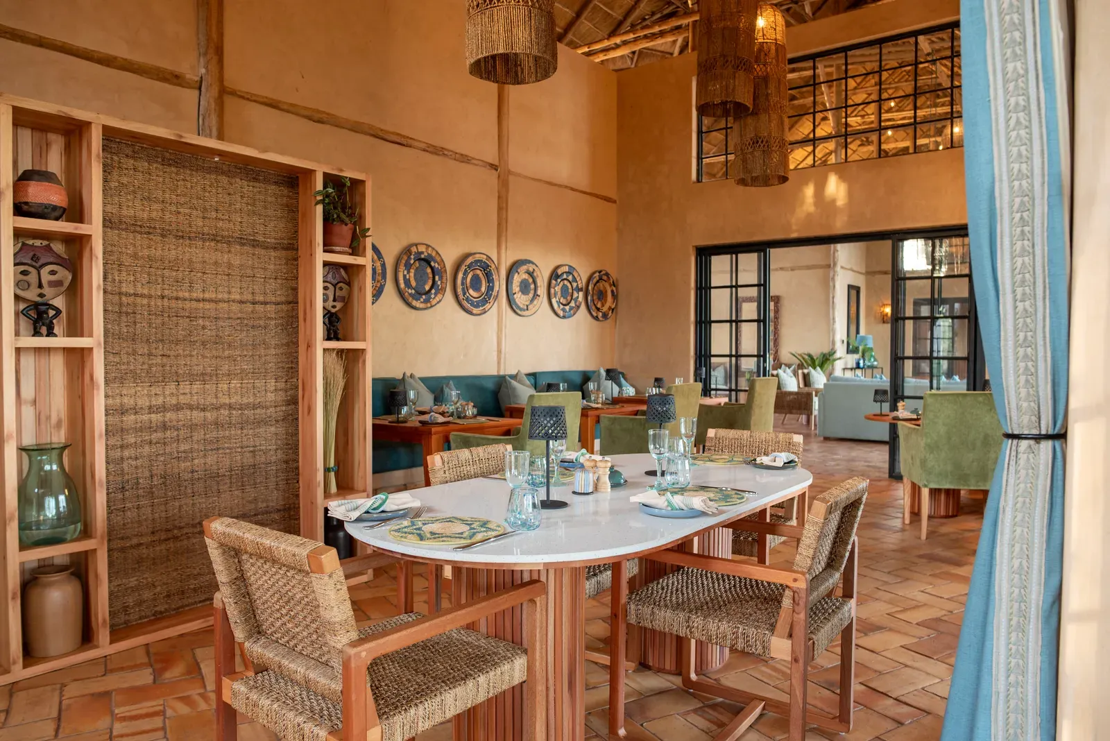 The dining and lounge area with African decor at Pabidi Lodge