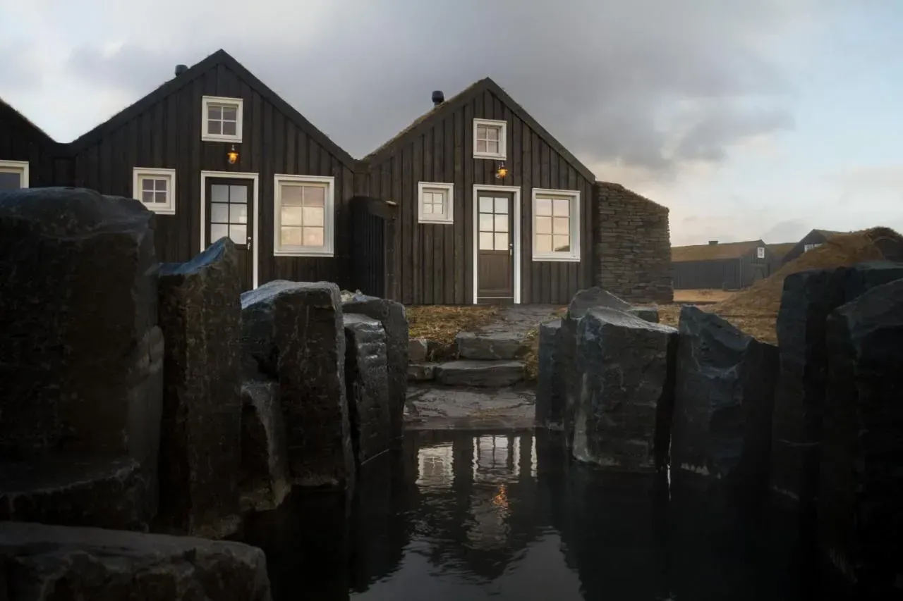 Turf-roofed timber villas with private geothermal hot pots at Torfhús Retreat on Iceland's Golden Circle