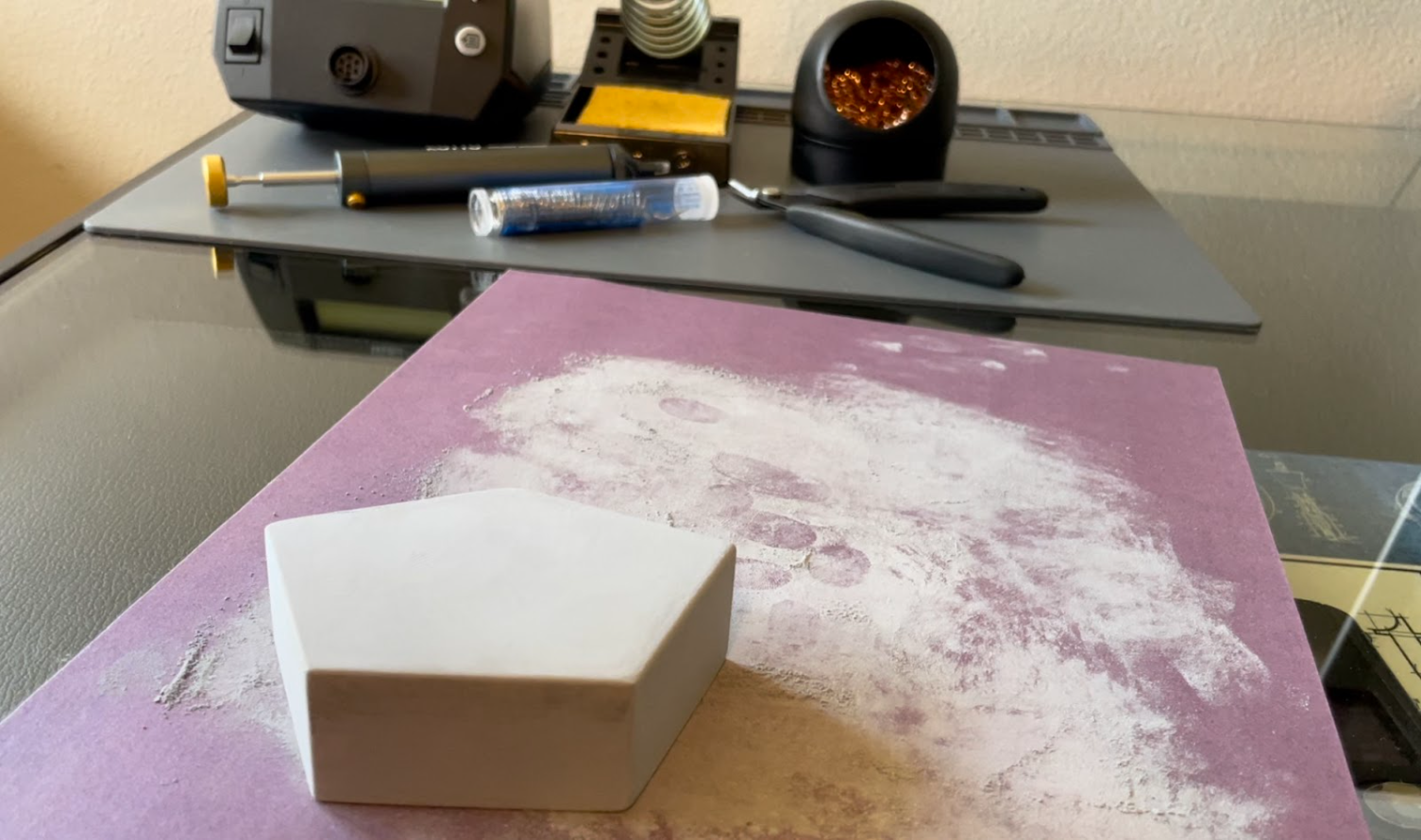 Sanding filler primed hexagon paver with 330 grit sandpaper.