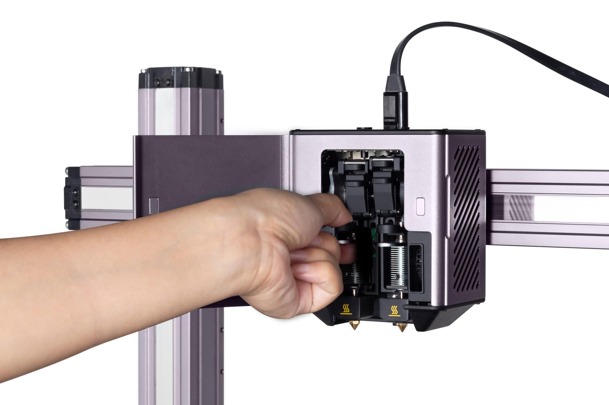 A user easily swapping a hot end on the Snapmaker Dual Extrusion module, revealing the internal gears of the extruder's "cold end" mechanism.