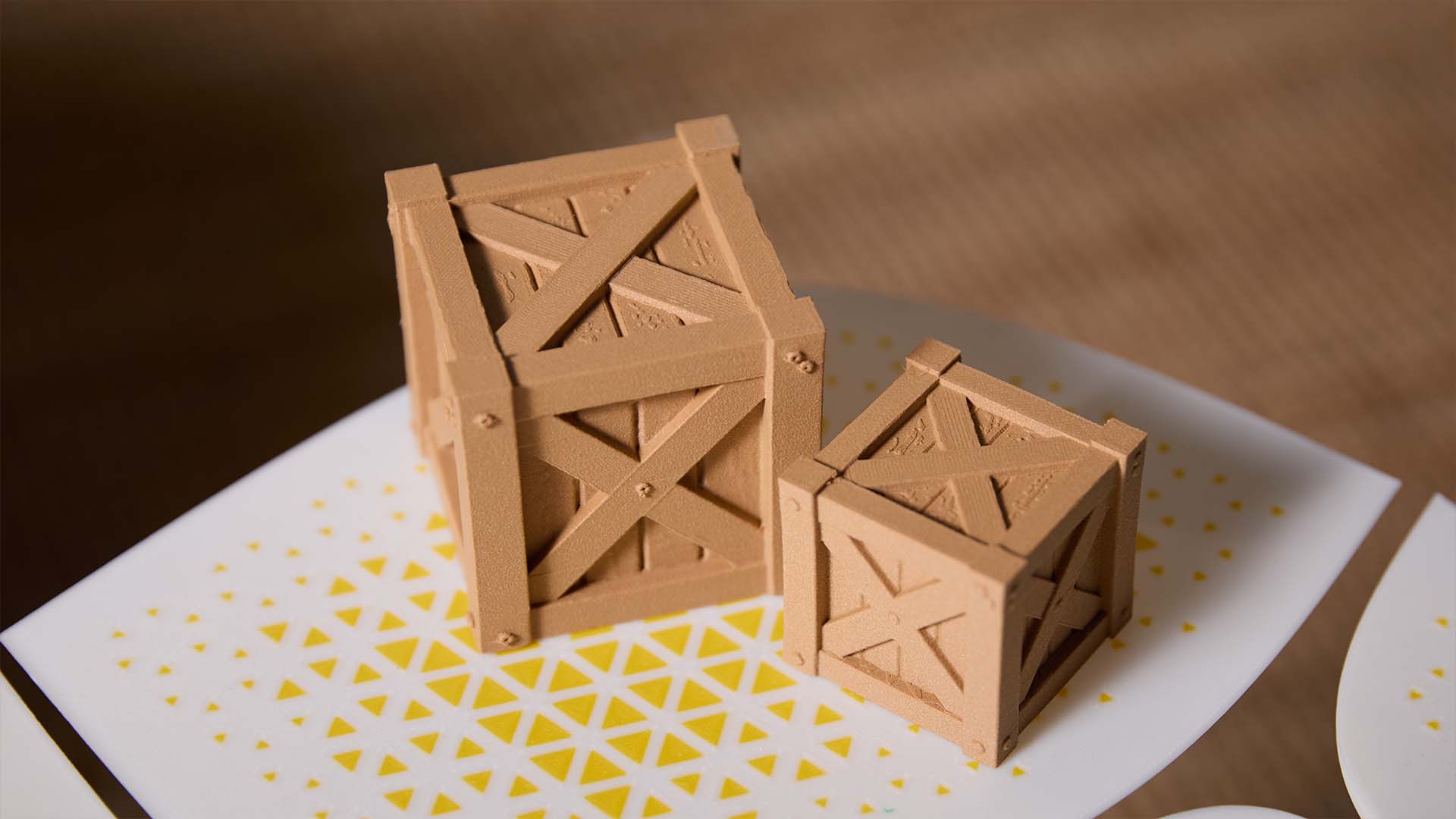Two 3D printed wooden crates of different sizes, showing the clean lines and wood-like texture created with wood PLA filament.