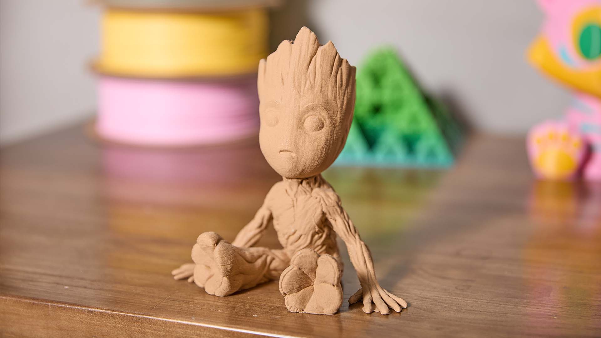 A 3D printed figurine of Groot with a realistic tree-bark texture, demonstrating a creative project idea for wood PLA filament.