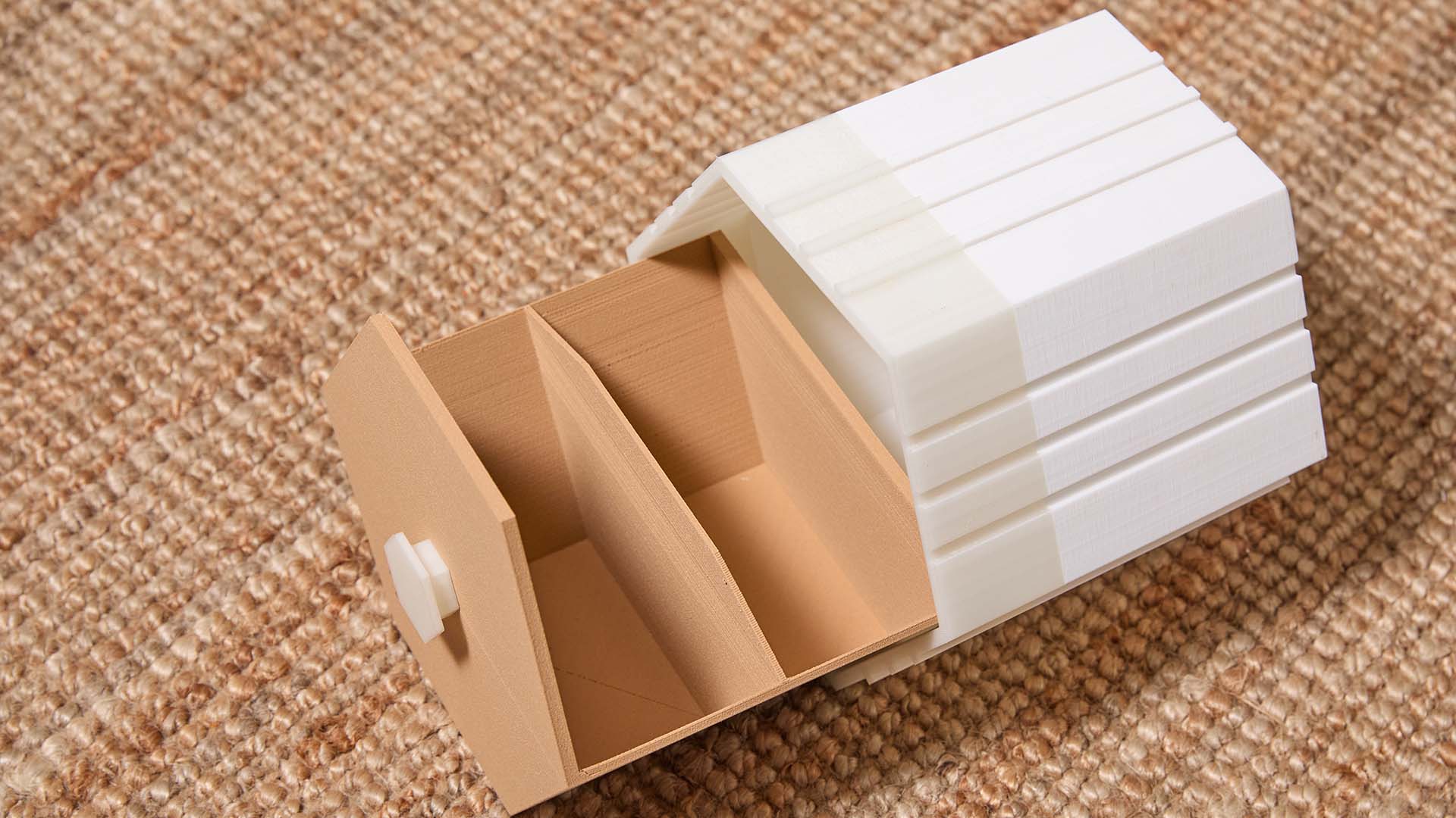 A functional 3D printed storage box with a white shell and a wood PLA sliding drawer with organizational compartments.