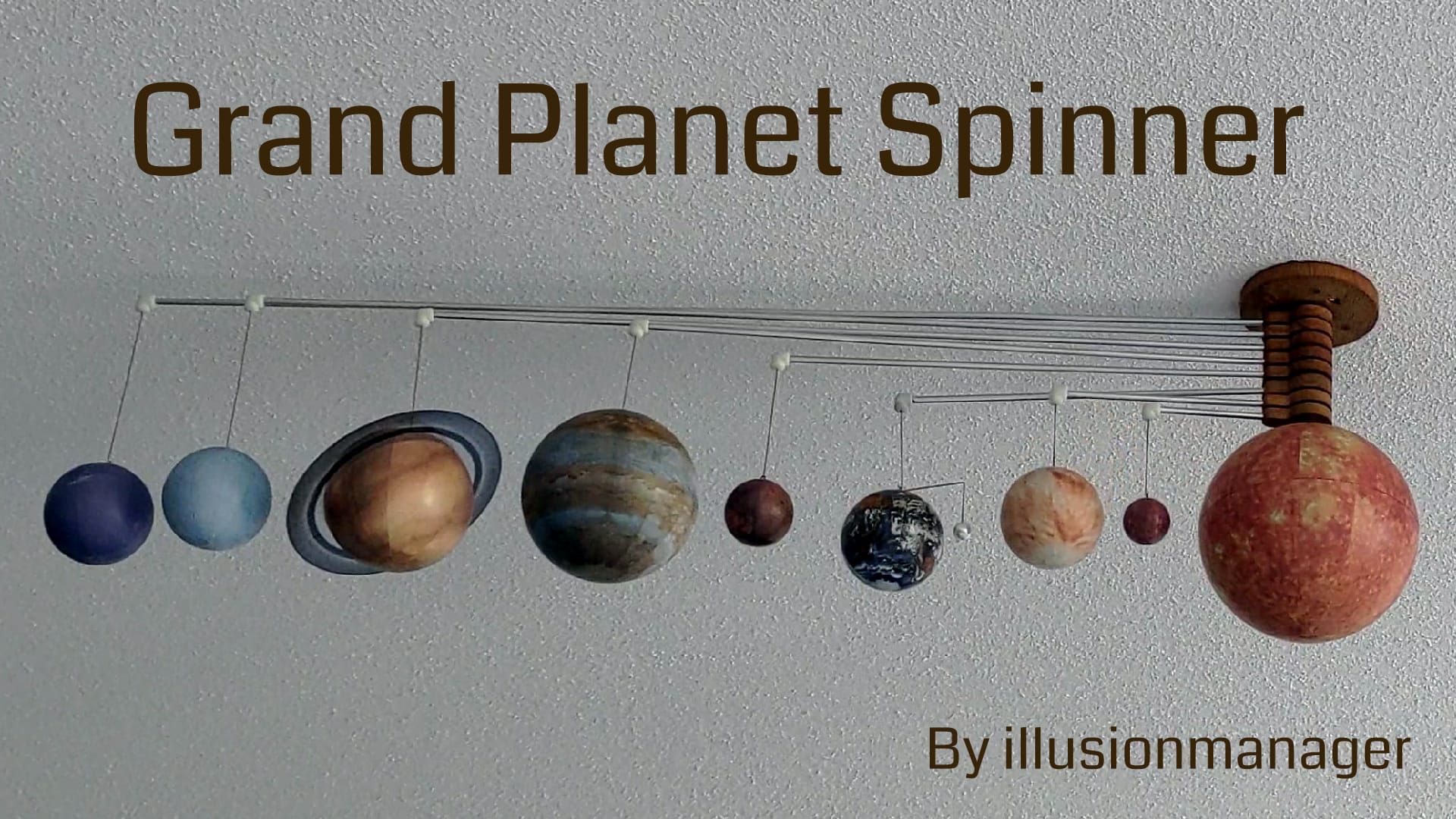 A laser-engraved wooden plaque shows a stylized depiction of the solar system with each planet orbiting a central sun.