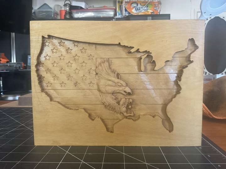 A highly detailed map of the United States is shown on a piece of wood.