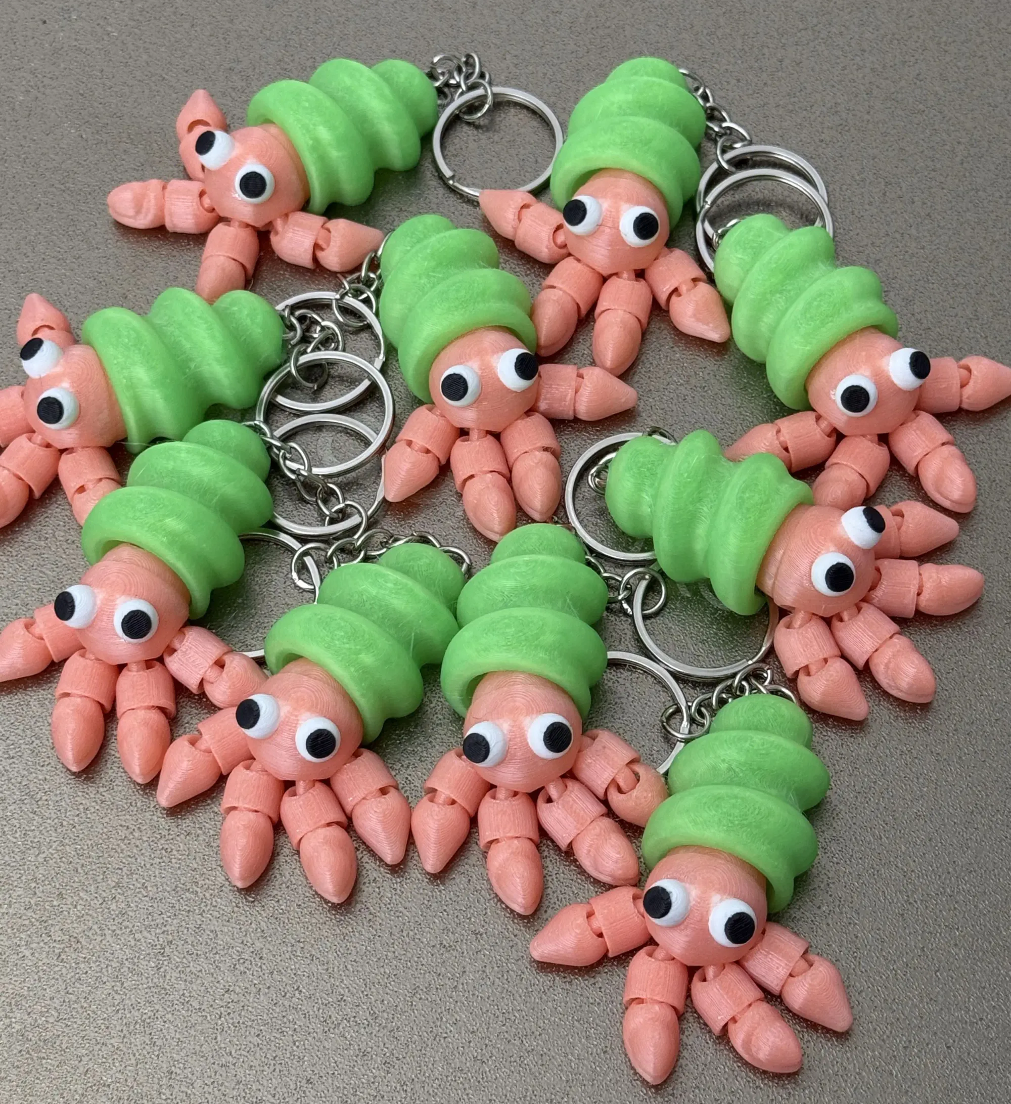 3D printed articulated hermit crab keychains demonstrating clearance fits, showing the intentional gaps between moving parts required for successful 3D printed assemblies.
