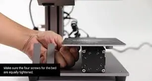 3D printer bed leveling with screw adjustment for perfect first layer.