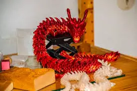 Articulated 3D printed dragon toy, a popular print-in-place beginner project made with flexible hinges.