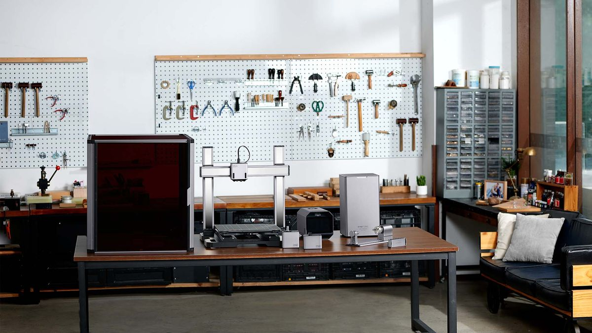 A well-organized 3D printing workshop with tools, machines, and a ventilated setup to prevent CA glue blooming.