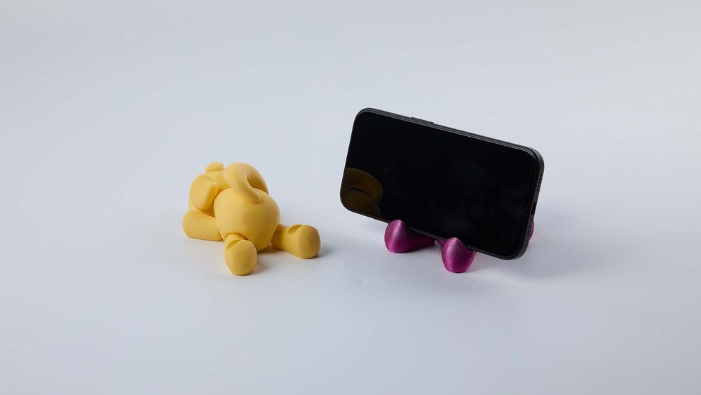 Cute animal-shaped 3D printed phone stand, a practical tech mount for desk use.