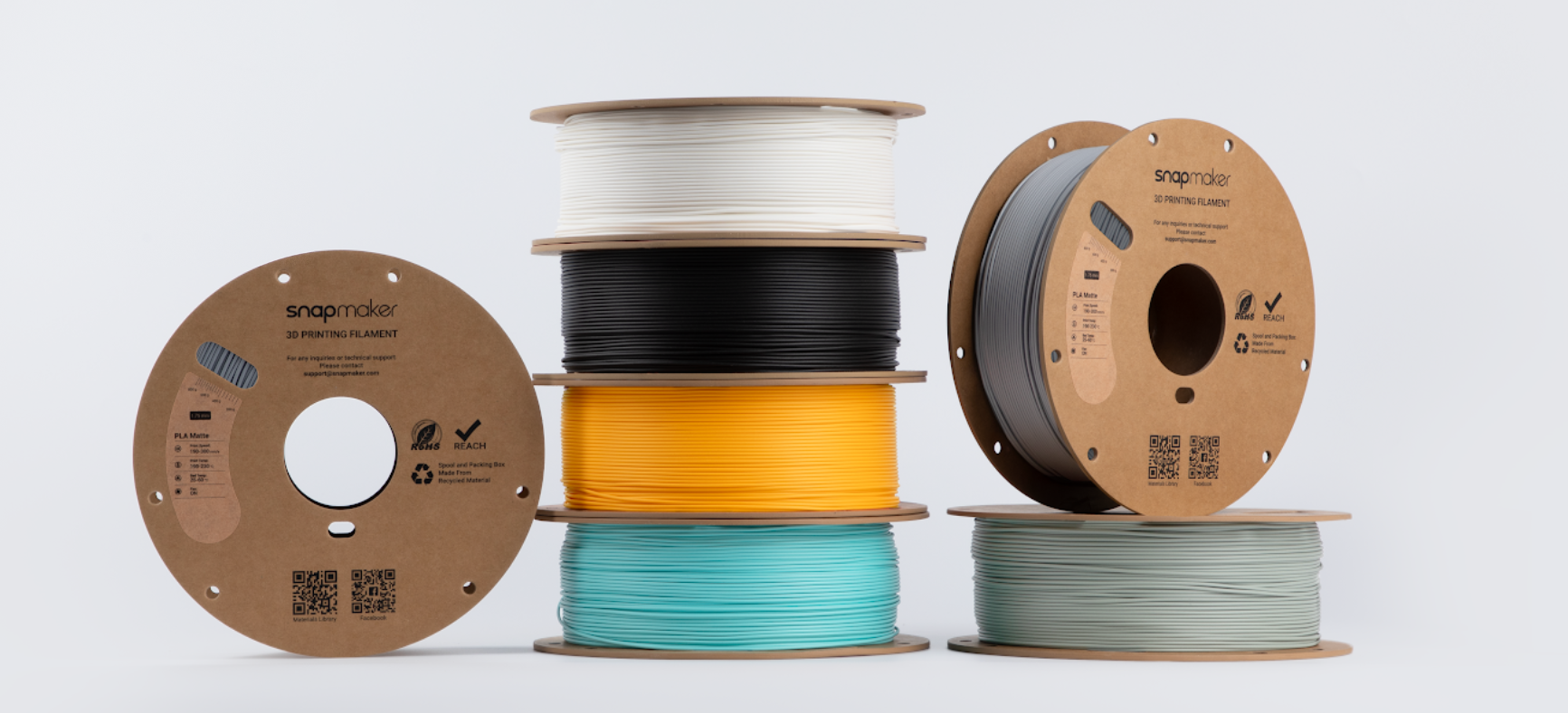 Snapmaker PLA 3D printing filament spools in multiple colors.