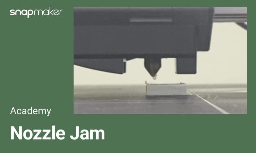 A photo of a 3D printer nozzle above a print bed, with the Snapmaker logo and text "Academy: Nozzle Jam" on a green background, illustrating a common 3D printing issue.
