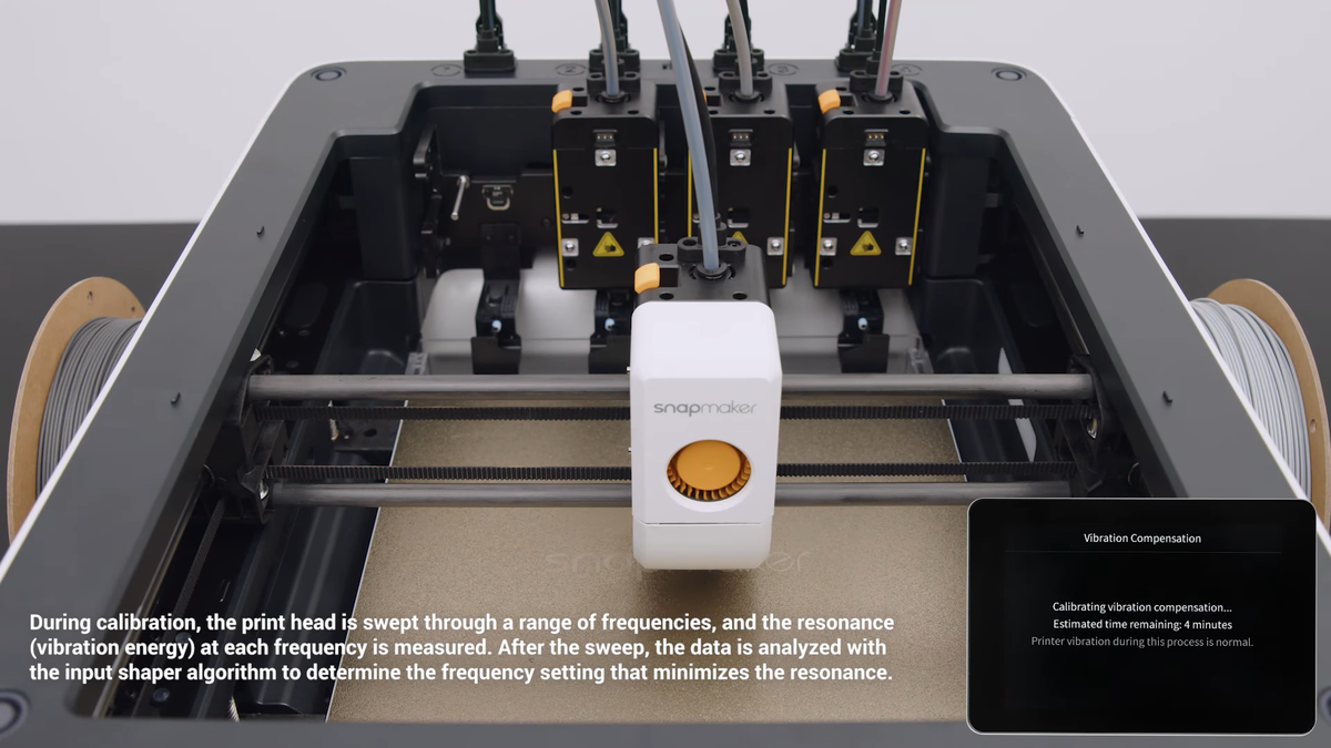 A close-up of a 3D printer running a vibration compensation calibration, a hardware feature that eliminates structural artifacts to ensure reliable and highly accurate strength testing.