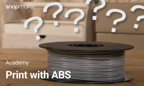 A Snapmaker ABS filament spool on a table showing the topic "How to 3D Print with ABS Filament"
