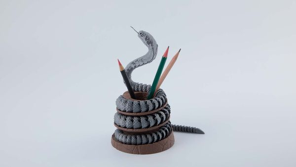 3D printed articulated cobra pencil holder, popular in 3D prints market.