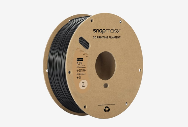 A 1kg spool of Snapmaker brand black ABS filament on a recycled cardboard spool, with the label showing its printing specifications.