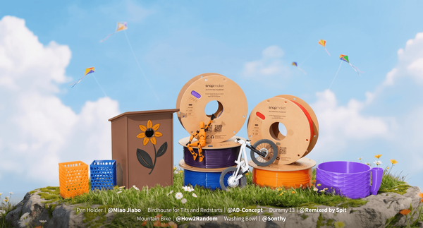 A collection of Snapmaker filament spools displayed alongside functional 3D printed models like a birdhouse and pen holders, illustrating the versatile applications of the material.