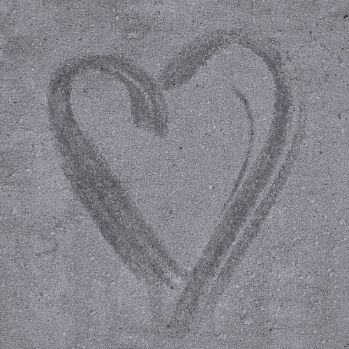 Faded heart on concrete, drawn with water.