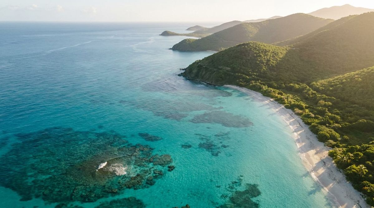 Aerial view of a turquoise Caribbean island coastline representing the five citizenship-by-investment nations