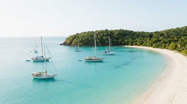 The turquoise Caribbean coastline of Antigua and Barbuda with sailboats